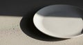 Round white ceramic plate sits on Royalty Free Stock Photo