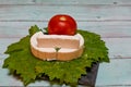 Round white homemade goat milk cheese on vine leaf on a wooden table Royalty Free Stock Photo
