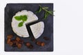 Round white homemade goat's milk cheese on a slate board with raisins Royalty Free Stock Photo