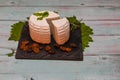 Round white homemade goat's milk cheese on wooden board Royalty Free Stock Photo