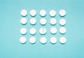 Round, white pills on a blue background. The concept of the treatment of the disease Royalty Free Stock Photo
