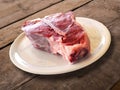 Round white plate with raw Fiorentina t-bone steak beef porterhouse