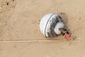 Round white polystyrene buoy a little tied to a rope network fishing fish on a wet sand background ocean design beach fishing