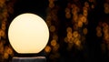 Round white street lamp shines with warm glow. Royalty Free Stock Photo