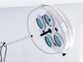 Round white swivel medical operating lamp with four blue turquoise glass lights in doctors office. White interier