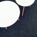 Round white tables on carpet floor Royalty Free Stock Photo