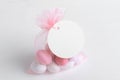 Round white tag mockup with gift with pink chocolate confetti in a bag with pink ribbon. Wedding favor tag for souvenir Royalty Free Stock Photo