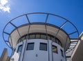 Round white top of a modern building against the blue sky Royalty Free Stock Photo