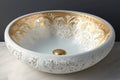 round white wash basin with gold accents and intricate designs