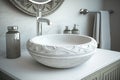 round white wash basin with silver faucet and matching towel bar