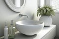 round white washbasin with silver faucet in sleek and modern bathroom
