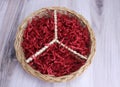 Round wicker basket with Peace symbol logo, filled with red confetti.. Valentines Peace Royalty Free Stock Photo