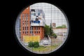 Round window overlooking the colorful buildings of the city