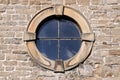 Round window in stone frame. Royalty Free Stock Photo