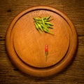 Round wood Chopping cutting board. chili peppers green and red Royalty Free Stock Photo
