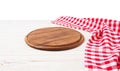 Round wood pizza cutting board and red napkin on wooden table isolated on white background. Top view and copy space, Empty Royalty Free Stock Photo