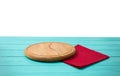 Round wood pizza cutting board and red tablecloth on blue wooden table isolated on white background. Top view and copy space, Royalty Free Stock Photo