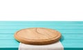 Round wood pizza cutting board and tablecloth on blue wooden table isolated on white background. Top view and copy space, Empty Royalty Free Stock Photo