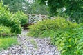 Round wooden bridge over the dry bed of a small river Royalty Free Stock Photo