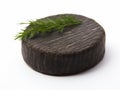 Round wooden coaster with a sprig of dill on a white background Royalty Free Stock Photo