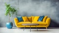 Round wooden coffee table near yellow sofa with yellow and blue pillows against blank concrete wall with copy space. Royalty Free Stock Photo