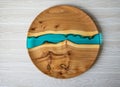 Round wooden craft tray with blue resin insert. Top view