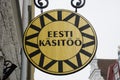 Round wooden sign of an estonian handicraft shop in Tallinn
