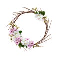 Round wreath from dry twigs with spring branches of peach flowers and leaves