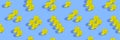 Round yellow pills on blue background. Seamless pattern. Horizontal banner, site header. Vitamin, beauty supplement