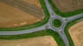 Roundabout from the air with red car on the country road - aerial view from above in the countryside Royalty Free Stock Photo