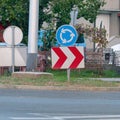 Roundabout and a red and white chevron right sign on the road