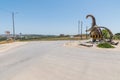 Roundabout road with a dinosaur model next to Dino Parque da Lourinha, Portugal on a sunny day