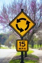Roundabout Sign in Front of a Budding Tree Royalty Free Stock Photo