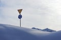 Roundabout signs and give way in winter among snowdrifts in Finland Royalty Free Stock Photo