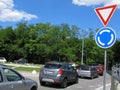 Roundabout traffic, road signs and cars on road