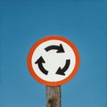 Roundabout traffic sign against sky Royalty Free Stock Photo