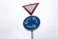 Roundabout traffic sign with sky in background Royalty Free Stock Photo