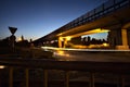 Roundabout under a viaduct in the italian countryside at night seen from a pavement by the edge of a road Royalty Free Stock Photo