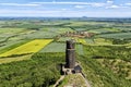 Rounded black tower of Hazmburk castle ruins with flat landscape below Royalty Free Stock Photo