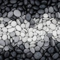 Rounded pebbles arranged in a gradient from dark at the top to light at Royalty Free Stock Photo