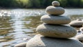 Rounded stones stacked in a balanced formation by a gently flowing Royalty Free Stock Photo