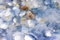 Rounded white stones under fresh transparent water