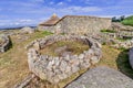 Roundhouse ruins and the reconstructed family nucleus building in Citania de Sanfins