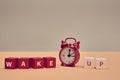 Rouse from sleep. Stop sleeping. Start new day. Awakening. Wake up inscription on wooden cubes. Alarm clock. Copy space Royalty Free Stock Photo