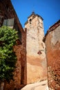 Roussillon: A narrow street in the beautiful French village of Roussillon, where the buildings are made with colorful, France Royalty Free Stock Photo