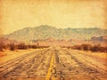 Route 66 crossing the Mojave Desert near Amboy, California, United States.  Photo in retro style. Added paper texture. Toned ima Royalty Free Stock Photo