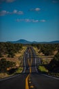 Route through. Landscape scene and sunrise above road. Asphalt highways and mountains under the blue sky.