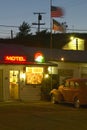 Route 66 neon sign and historic vintage roadside motel welcomes old cars and guests in Barstow California