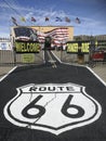 Route 66 painted at the street with a typical route 66 shop in the background
