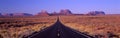 This is Route 163 that runs through the Navajo Indian Reservation. The road runs up the middle and gets smaller into infinity. The Royalty Free Stock Photo